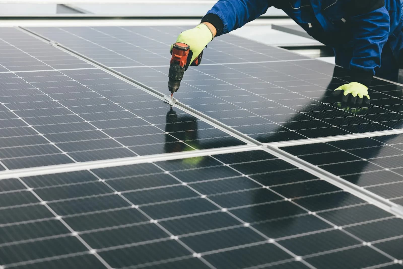 Technician fixing a solar module to its frame